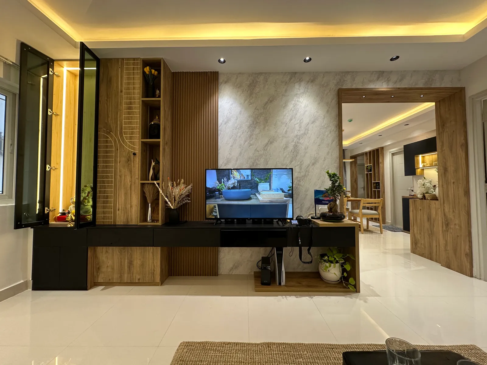 Living room with black and oak TV unit and glass display cabinet — The Aakar